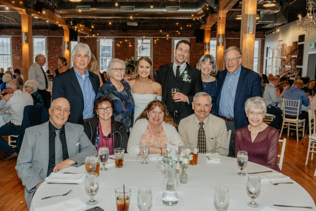 table dash photo of bride and groom with guests 