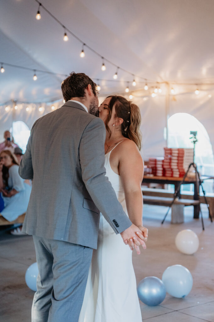 bride and groom kiss during first dance