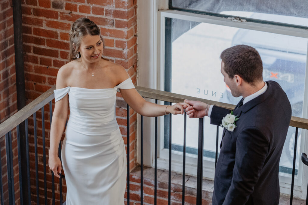 Bride and groom admiring one another during first look at VX Venue