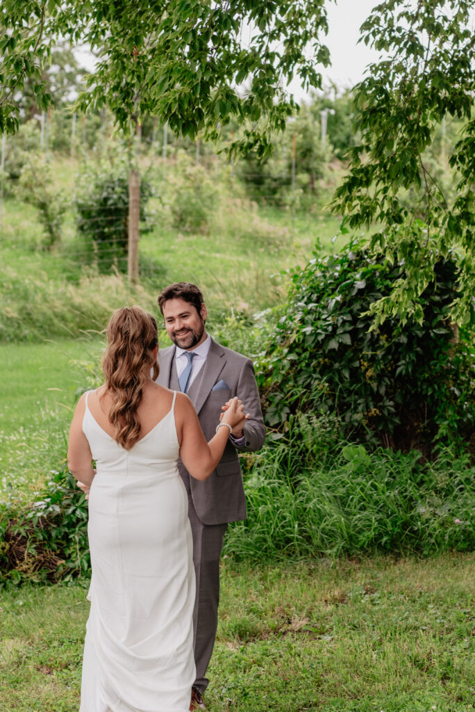 groom's reaction to bride during first look at Deer Lake Orchard