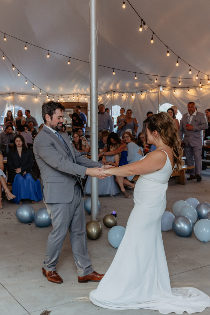 bride and groom fun first dance at tent wedding