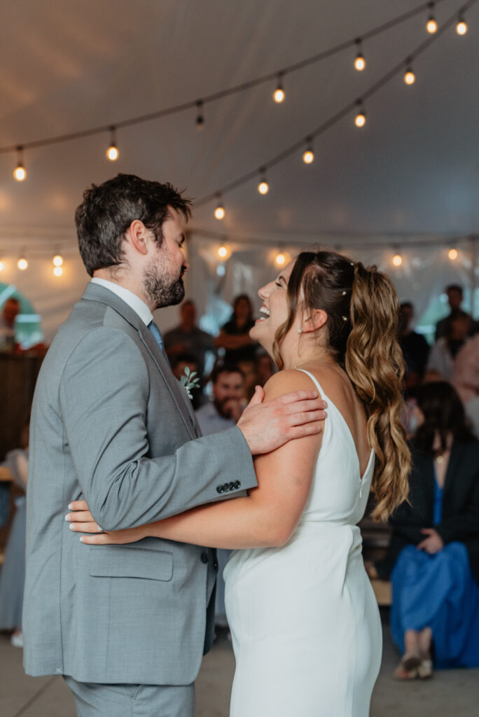 bride and groom laughing during first dance at Deer Lake Orchard wedding