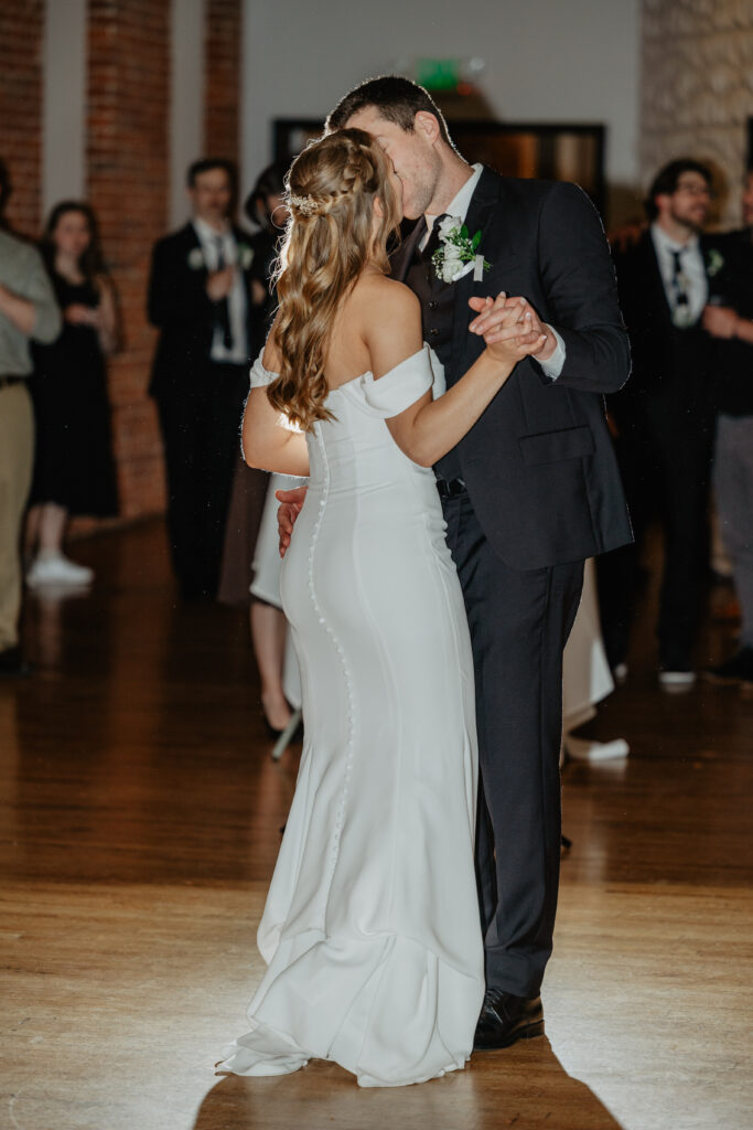 bride and groom intimate kiss during timeless wedding first dance