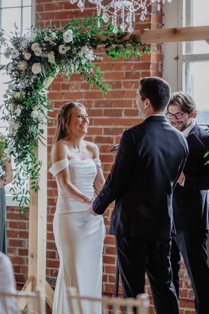 bride and groom laughing during emotional wedding ceremony