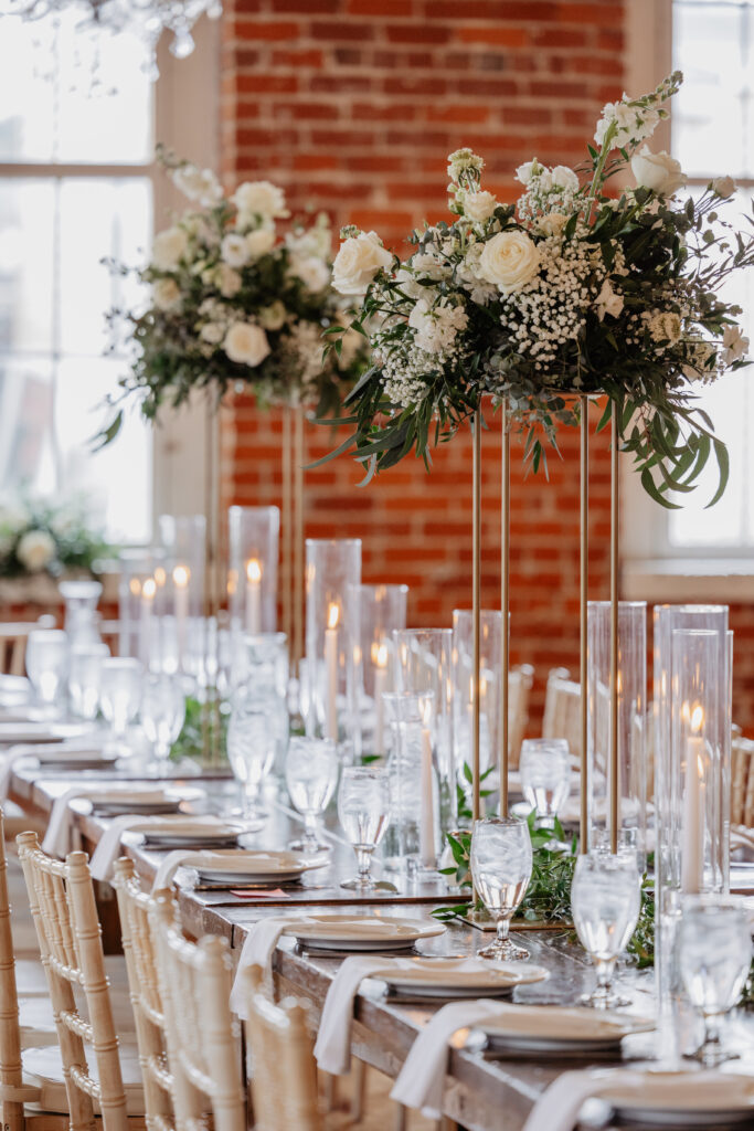 classic timeless wedding head table with white tall arrangements and taper candles