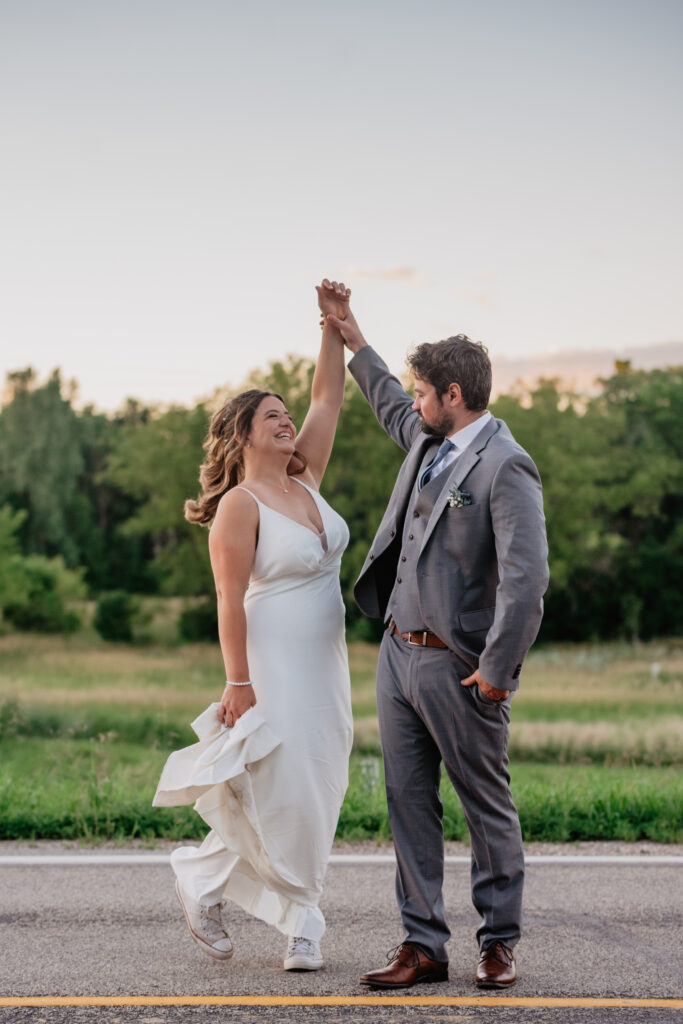 groom spinning bride during sunset at Deer Lake Orchard Wedding