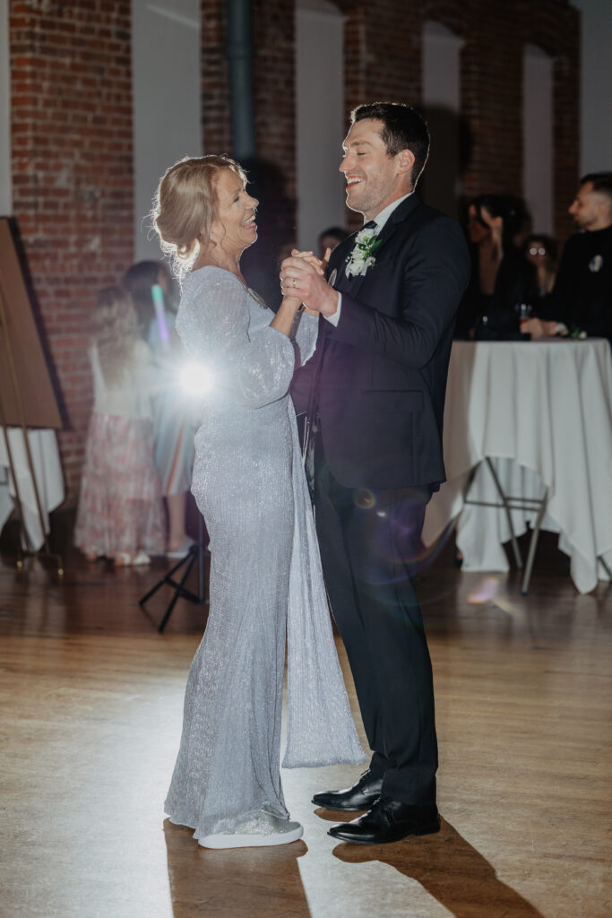 groom and mother laughing during first dance