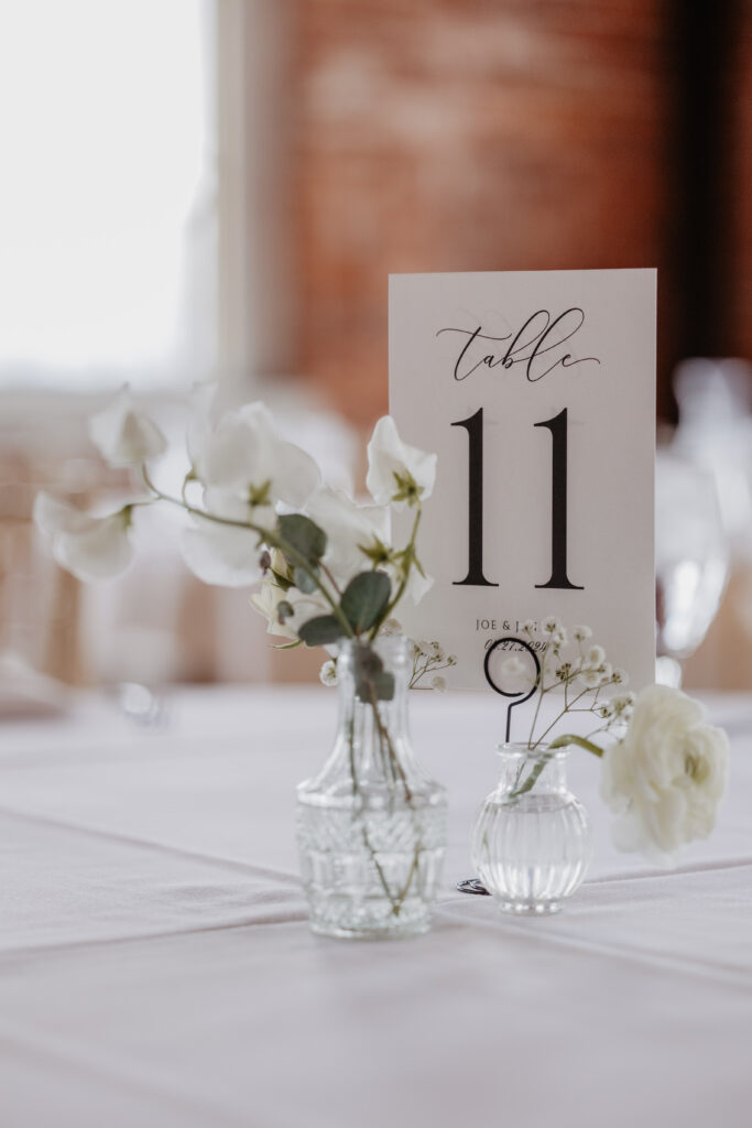 simple timeless centerpieces with white flowers in glass bud vases