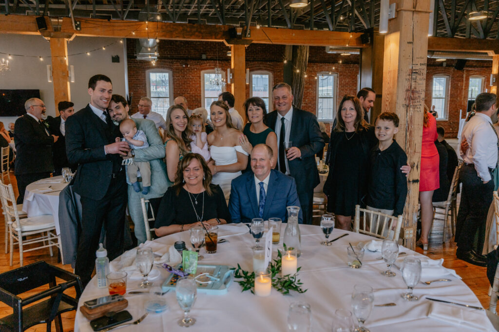 bride and groom photo with guests during table dash