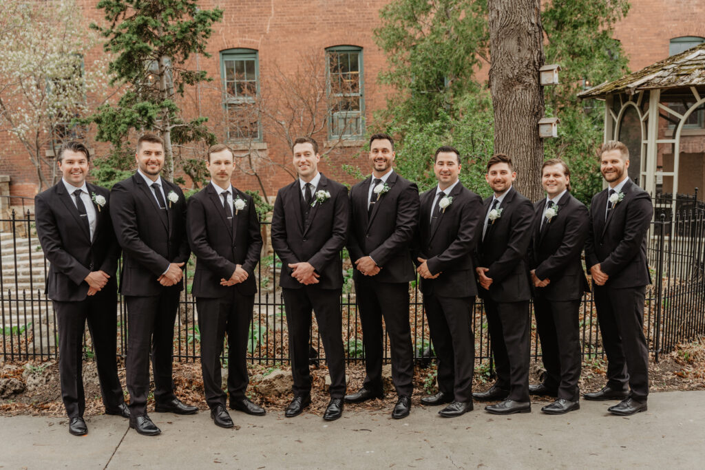 groomsmen timeless wedding portrait lined up in black suits