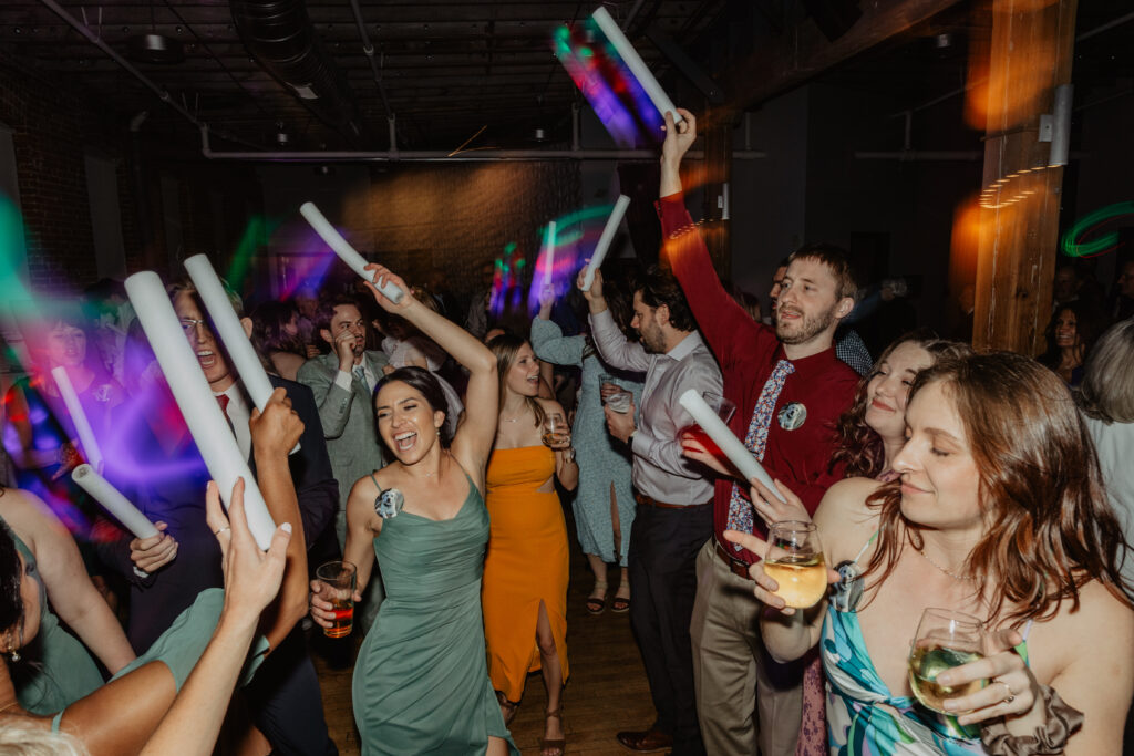 epic wedding party dance floor with colorful light up wands